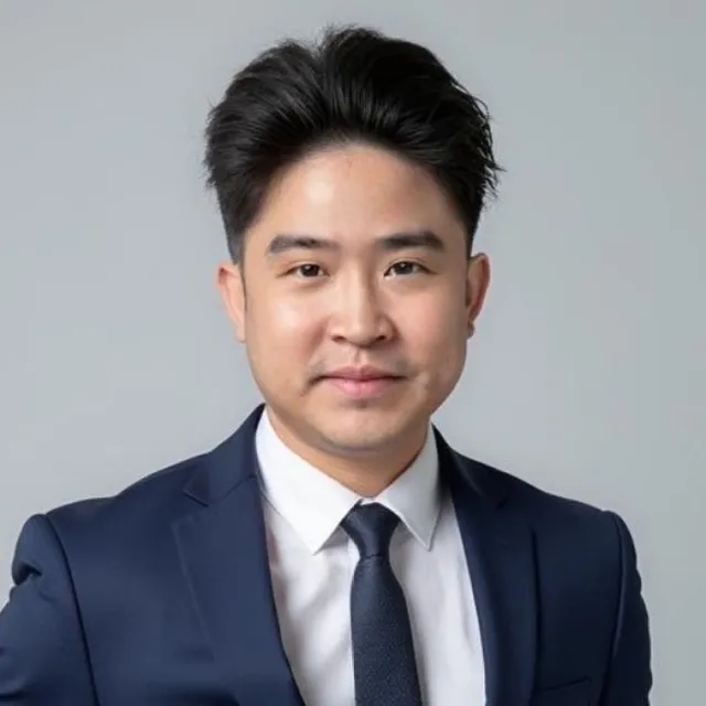 Jadon Cruz Montero, in a navy suit and tie, looking straight at the camera.