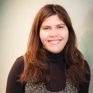 Jen Andre, smiling, with long dark hair and a black turtleneck.